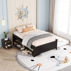 a small bed sitting on top of a wooden floor next to a white and blue wall