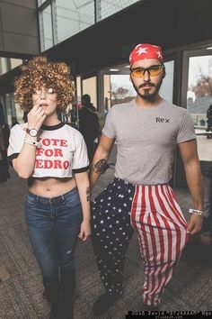 a man and woman are walking down the street with american flags on their leggings