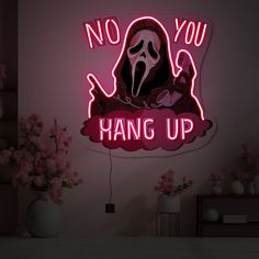 there is a neon sign that says no you hang up with a ghost on it