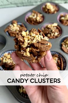 a person holding up a chocolate cupcake in front of a muffin tin filled with it