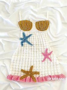 a crocheted dress with starfishs on it