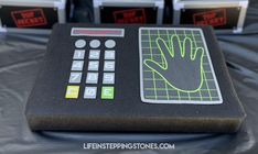 a table with some kind of electronic device on it's display stand and four boxes behind it