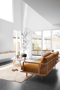 a living room filled with furniture and windows