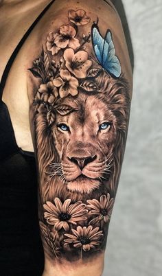 a woman's arm with a lion and flowers on it