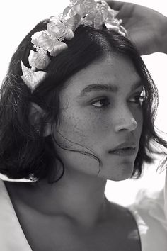 black and white photograph of a woman with flowers in her hair