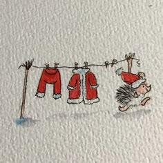 a drawing of clothes hanging on a line with a hedgehog in the foreground