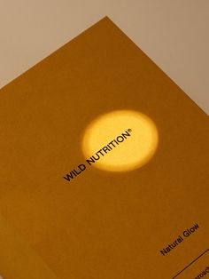 a yellow book with the word wild nutrition on it's cover and a bright spot in the middle