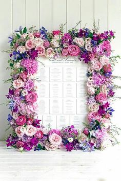 a floral frame table plan with pink and purple flowers