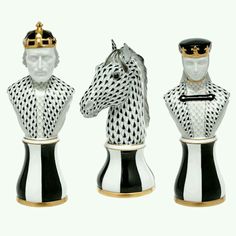 three pieces of chess set with black and white figures on top of each other, one wearing a gold crown