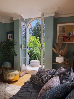 a living room filled with furniture and an open door