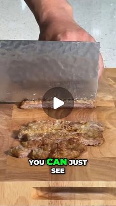 someone is cutting meat with a knife on a wooden board that says, you can just see