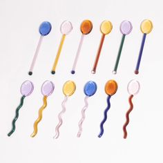 six different colored plastic spoons with long handles