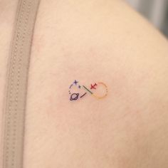 a small tattoo on the back of a woman's shoulder