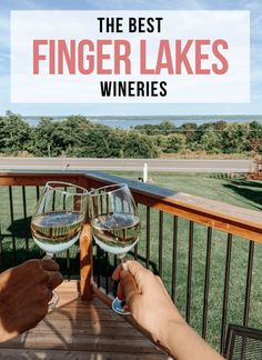 two people toasting wine glasses on a deck with the words, the best finger lakes wines