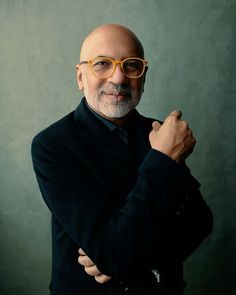 an older man with glasses posing for a photo