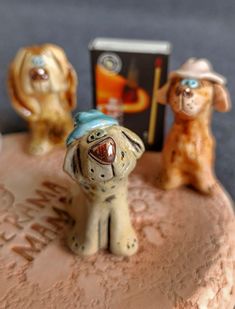 three ceramic dogs sitting on top of a table