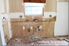 an unfinished bathroom with the walls torn off