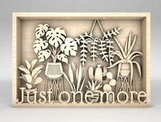 a wooden cutout with the words justonemore surrounded by flowers and plants