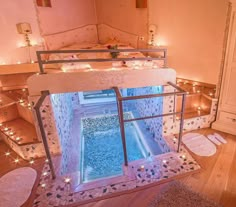 a room with stairs and lights on the walls, in which there is a small pool