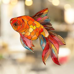 a colorful glass fish hanging from the ceiling