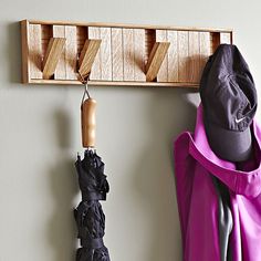 two umbrellas are hanging on the wall next to a coat rack and hat rack