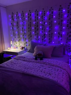 a bedroom with purple lights on the wall