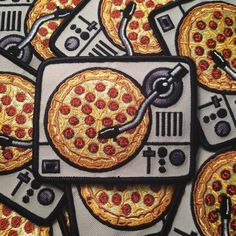 a bunch of pizzas that are on some kind of table cloth with different designs