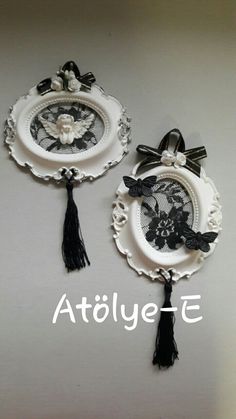 two white plates with black lace and bows on them, one has a bow at the top