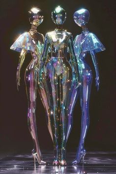 three shiny mannequins standing next to each other