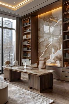 an office with large windows and a marble desk in front of a bookcase filled with books