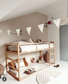 there is a bunk bed in the room with bunting flags on the wall above it