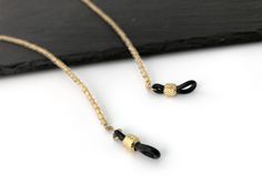 This crystal gold lined eyeglasss holder necklaces are made of Czech Fire Polished beads. It goes well with all your reading glasses and gives you a perfect elegant look, an ideal gift for women. EC019 * Quantity: 1pc * Materials: - 4mm Czech Fire Polished Crystal Gold Lined - Rubber connector * Measurement: Total length 75cm(29.5inch) including adjustable rubber end connectors * Metal Color: Gold * No return or refund for this made to order item. For more eyeglass chains, please visit this link Adjustable Gold Beaded Necklace With Chain, Gold Beaded Glass Jewelry, Gold Glass Jewelry With Gold Beads, Gold Glass Beaded Necklaces, Glass Necklaces With Gold Chain For Gift, Handmade Gold Glasses Chains With Round Beads, Gold Glass Glasses Chains Gift, Elegant Glass Beaded Necklace With Adjustable Chain, Gold Glass Jewelry With Beaded Chain