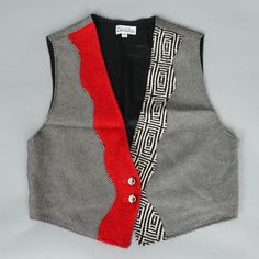 A vintage black, red and white geometric and pinstripe women's vest from the 1980s. The pre-owned modernist style vest was made in the USA. The tag reads "Original Knits by Jean Sweet." Vest is size medium. Retro Black Winter Vest, Fitted Retro Red Vest, Fitted Red Retro Vest, Retro Red Fitted Vest, Retro Red Sleeveless Vest, White Sleeveless Patchwork Vest, Retro Red Cotton Vest, Fitted Vintage Multicolor Vest, Retro Cotton Patchwork Vest