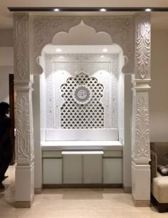 a white room with an intricate design on the wall