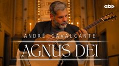 a man playing an acoustic guitar with the words agnis dei in front of him