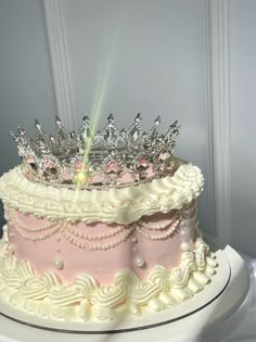 a pink and white cake with a tiara on top