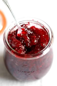 a jar filled with jam sitting on top of a table