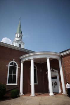 a church with columns and a clock tower