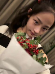 a young woman holding a bouquet of flowers