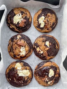 chocolate chip cookies with white butter on top in a baking pan, ready to be eaten