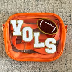 an orange bag with the word volls on it and a football in the middle