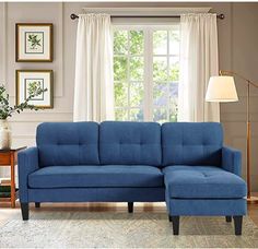 a blue sectional couch in front of a window