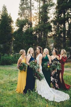 a group of women standing next to each other on top of a lush green field