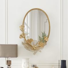 a mirror hanging on the wall above a dresser