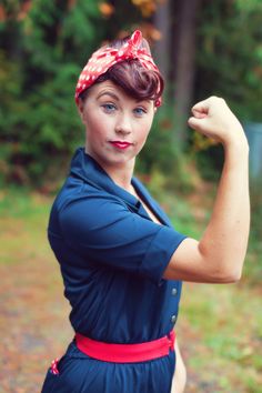 a woman with a red bandana on her head and arms is posing for the camera