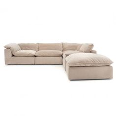 a large sectional couch with pillows on the top and bottom corner, in beige color