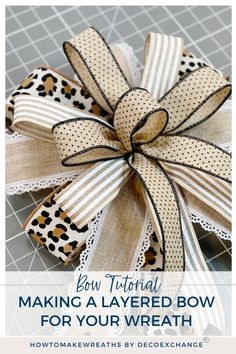 a bow that has been made with leopard print ribbon and is sitting on top of a table