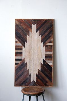 a wooden wall hanging next to a stool