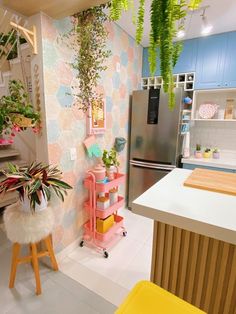 a kitchen with a refrigerator and some plants in it