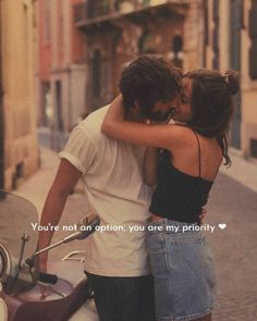 two people standing next to each other on a scooter with the caption you're not an option, you are my priority